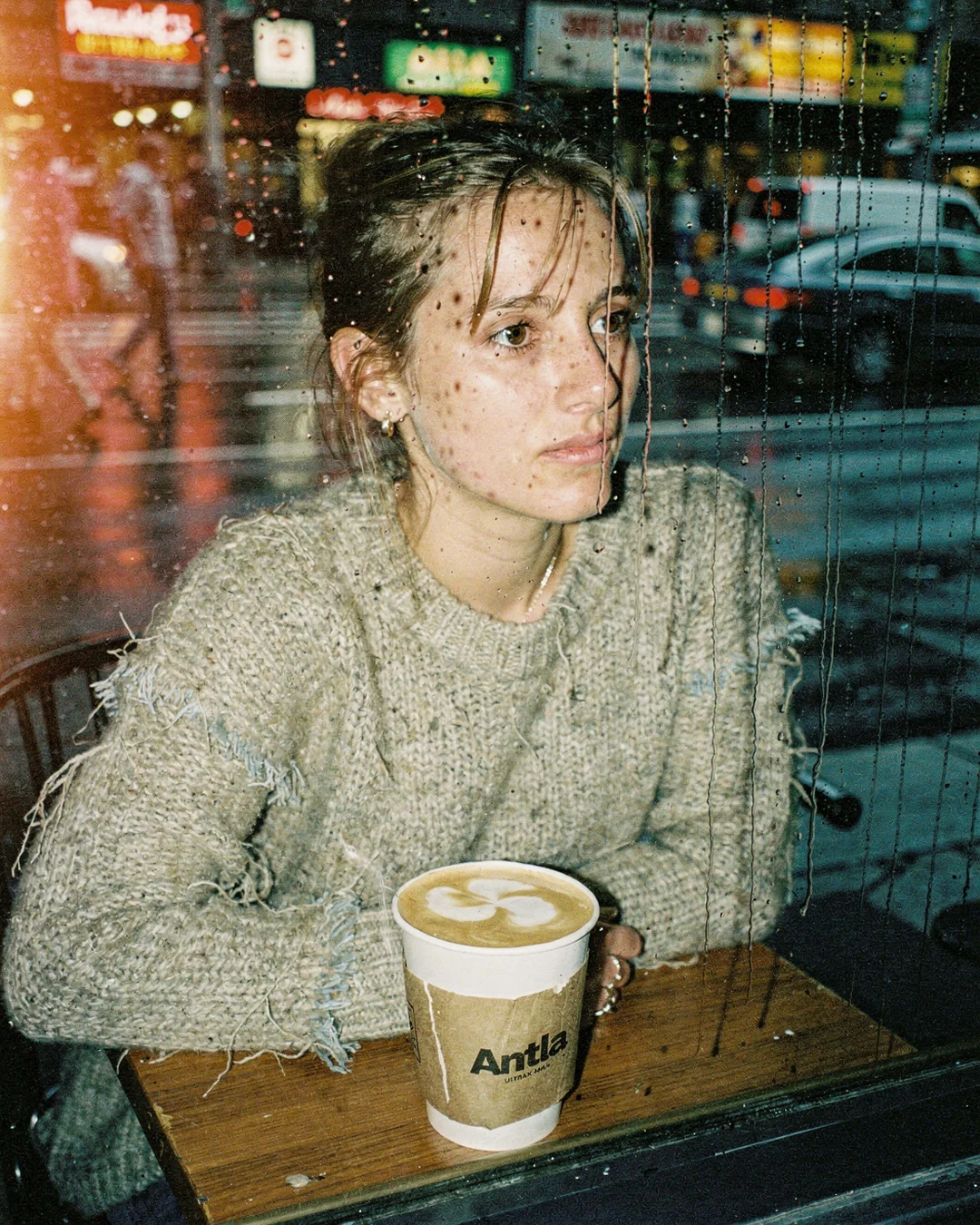 Rain-streaked coffee shop window portrait in disposable-camera style, representing Shopify Plus personalization and personal buying journeys
