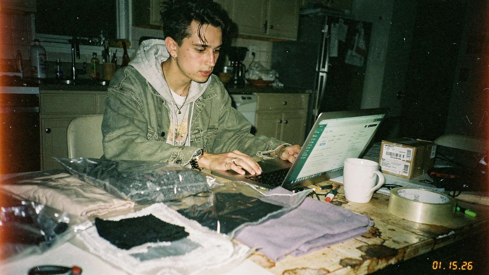 Founder planning a new Shopify fashion store with product samples and a laptop, representing how to start an online fashion business in 2026