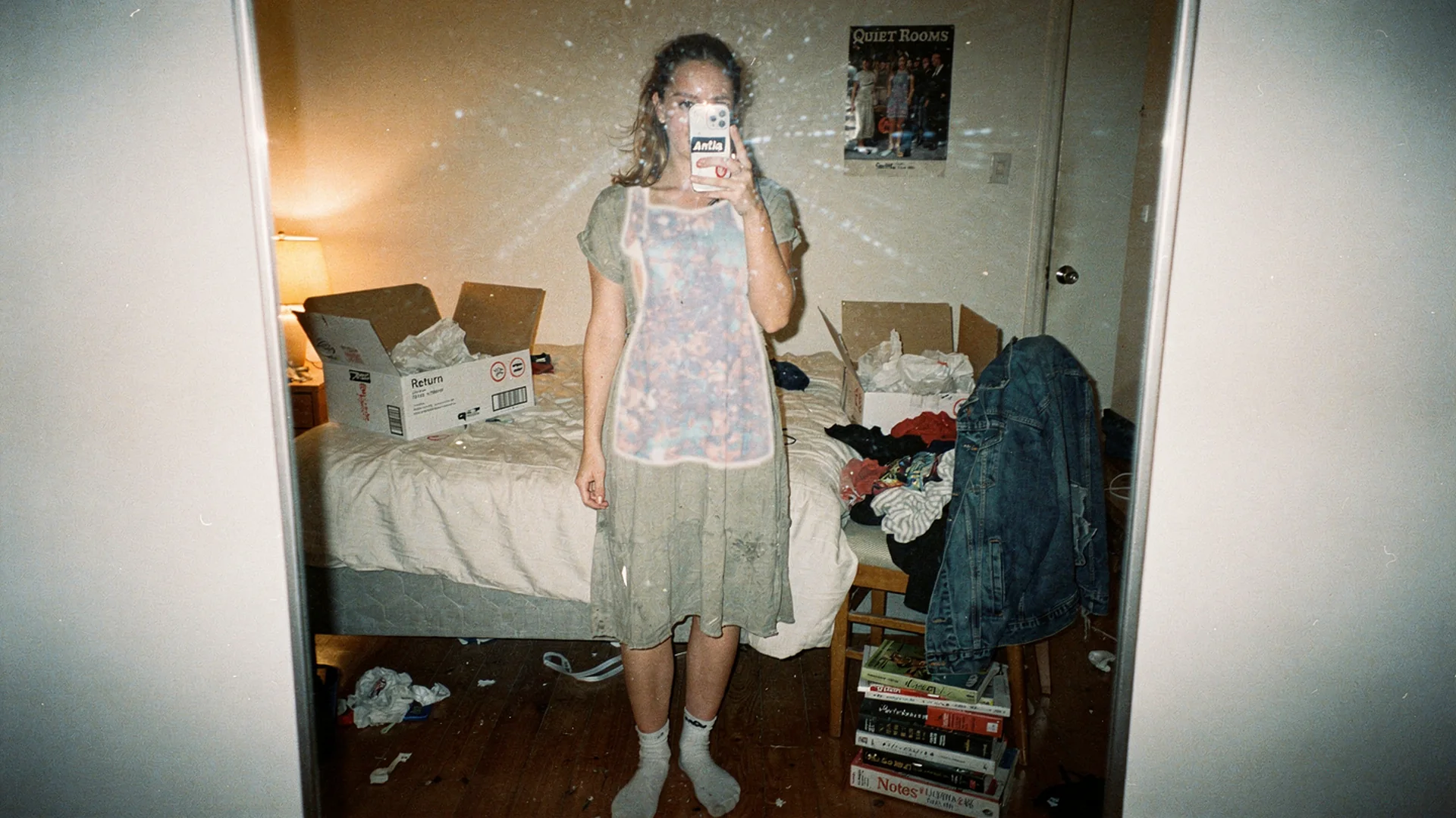 Bedroom mirror selfie with phone showing virtual try-on on a midi dress, evaluating best try-on for Shopify fashion