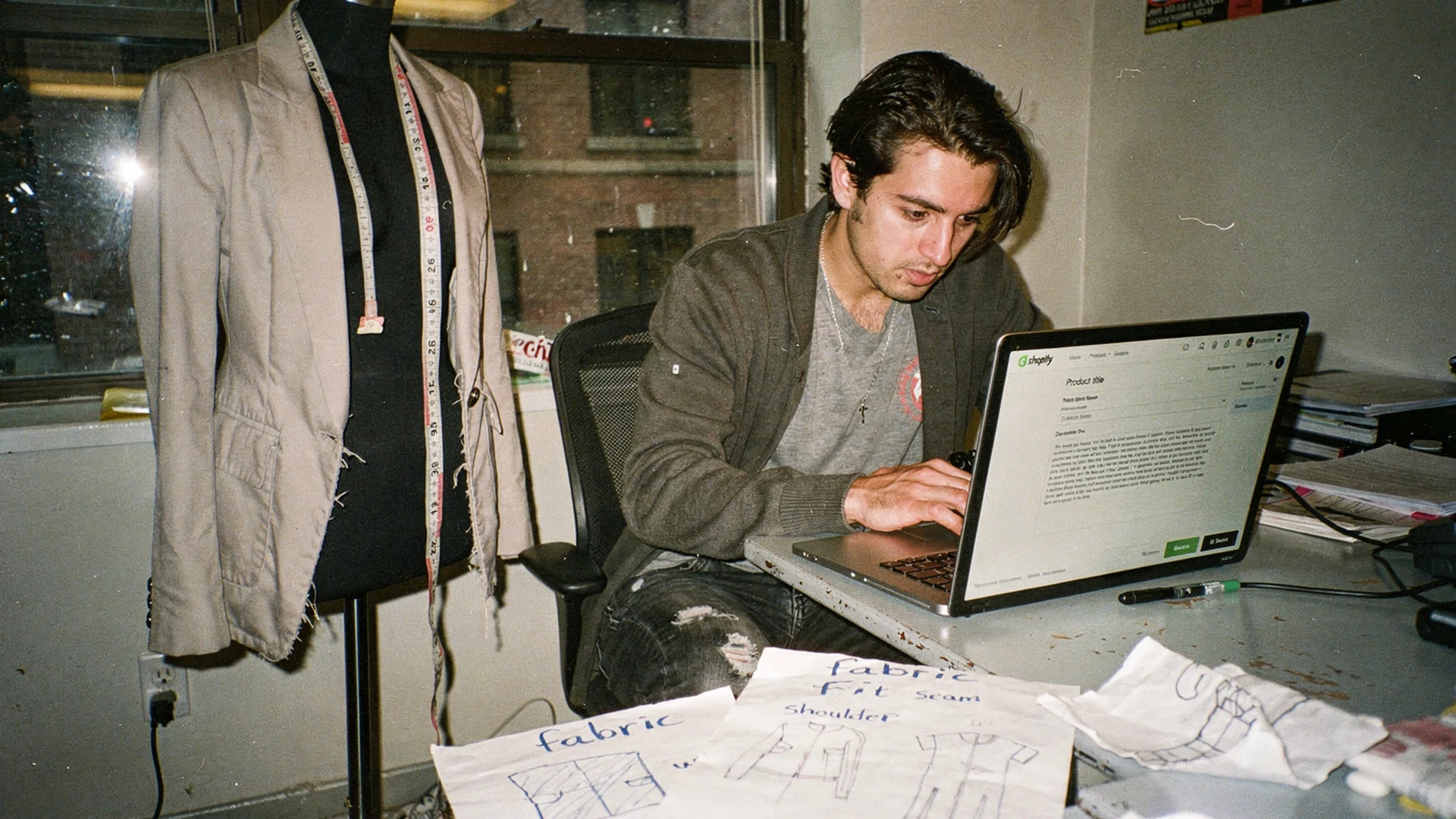 Merchant editing AI-generated fashion product copy in Shopify admin beside fabric swatches and measurement notes