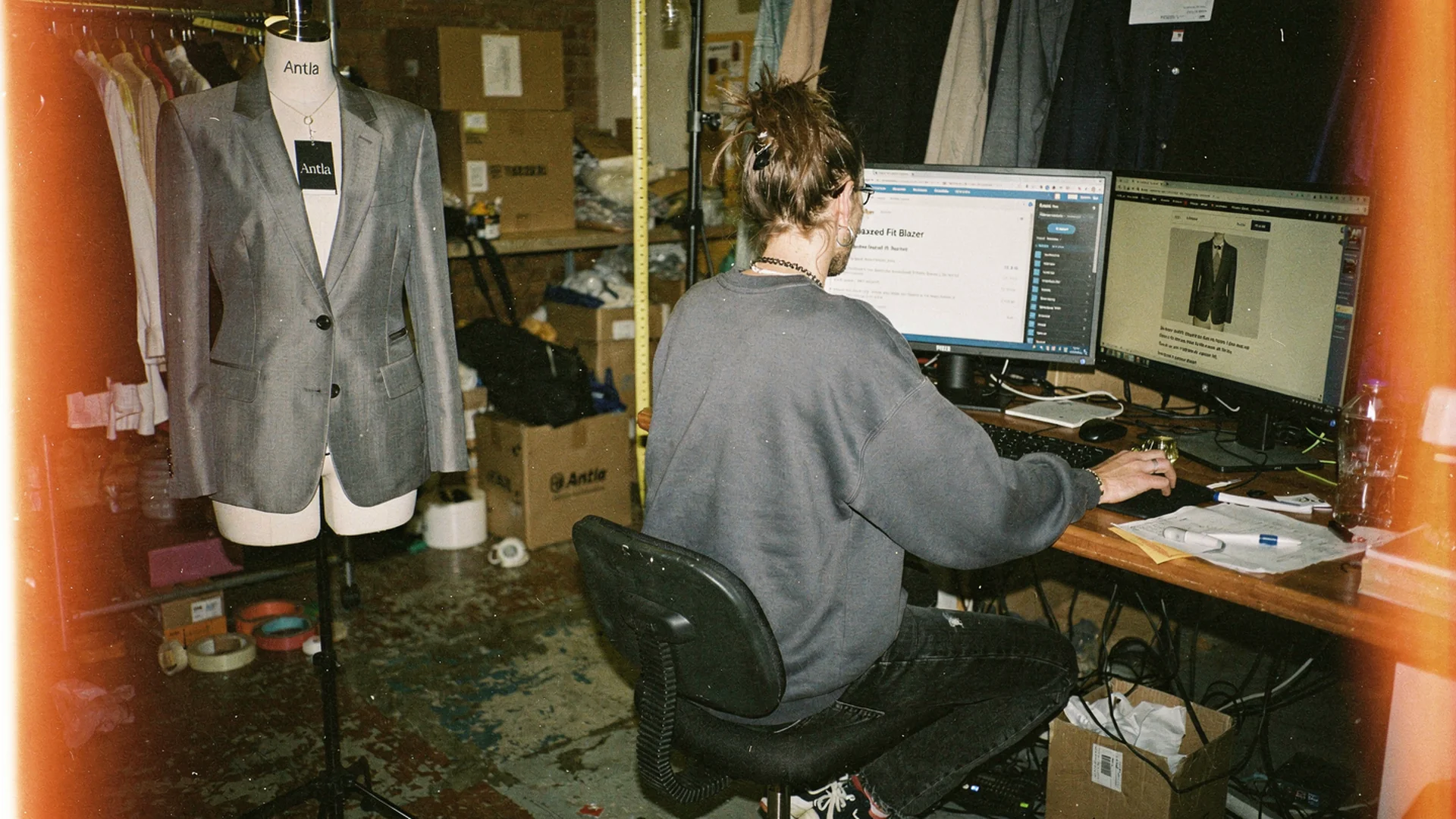 Product page editor reviewing AI-generated fit bullets beside a blazer on a form and Shopify PDP preview