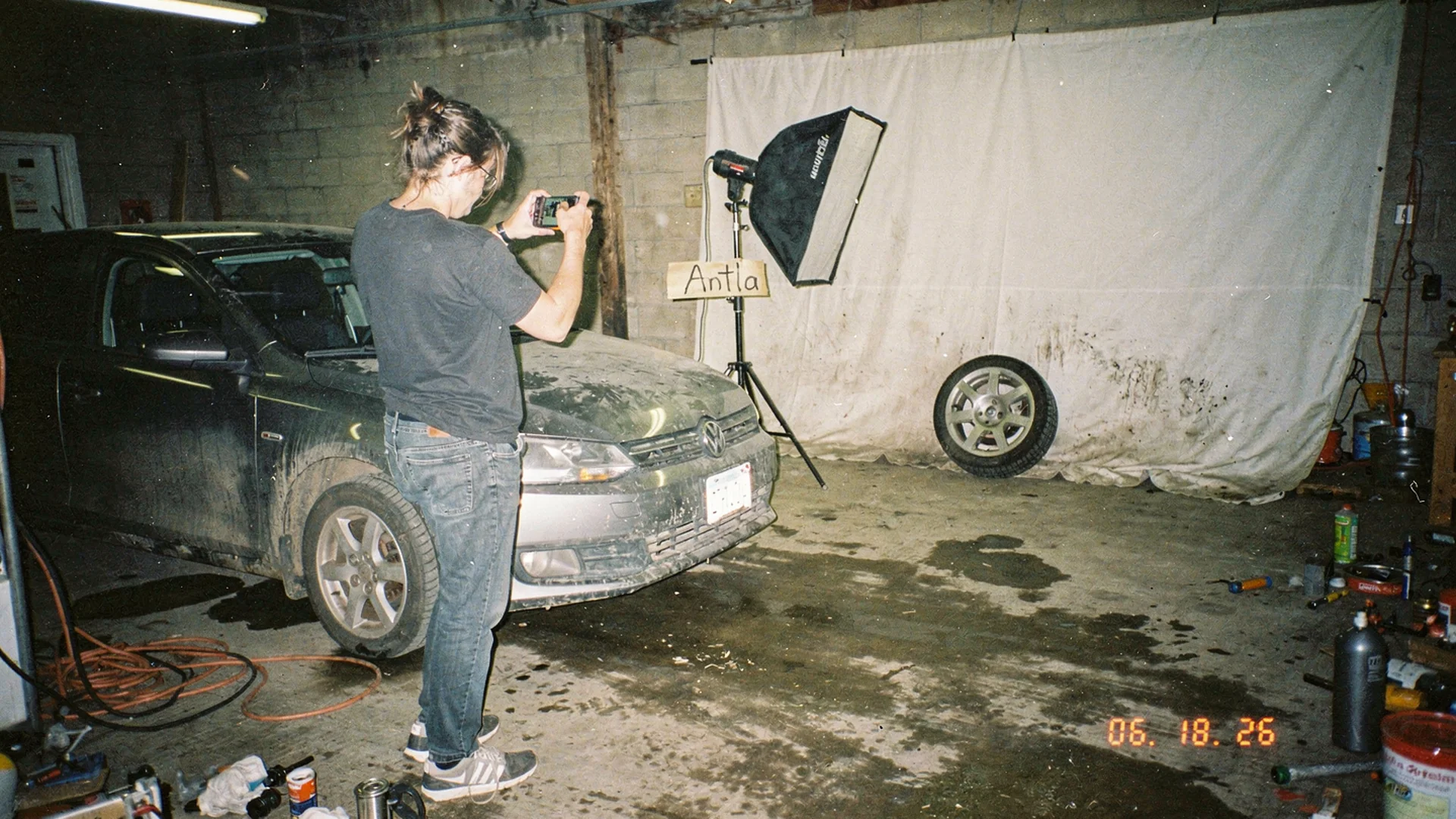 Split editorial scene with polished wheel product photography on one side and phone showing AI wheel preview on a shopper car photo on the other