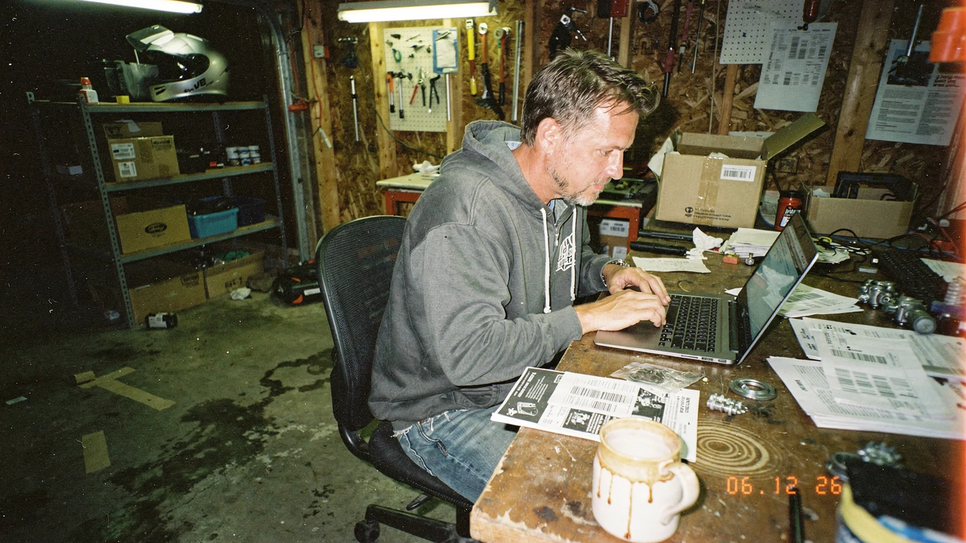 Aftermarket parts merchant configuring Antla Custom Funnel in Shopify admin with wheel and motorcycle product tabs on a laptop in a garage office