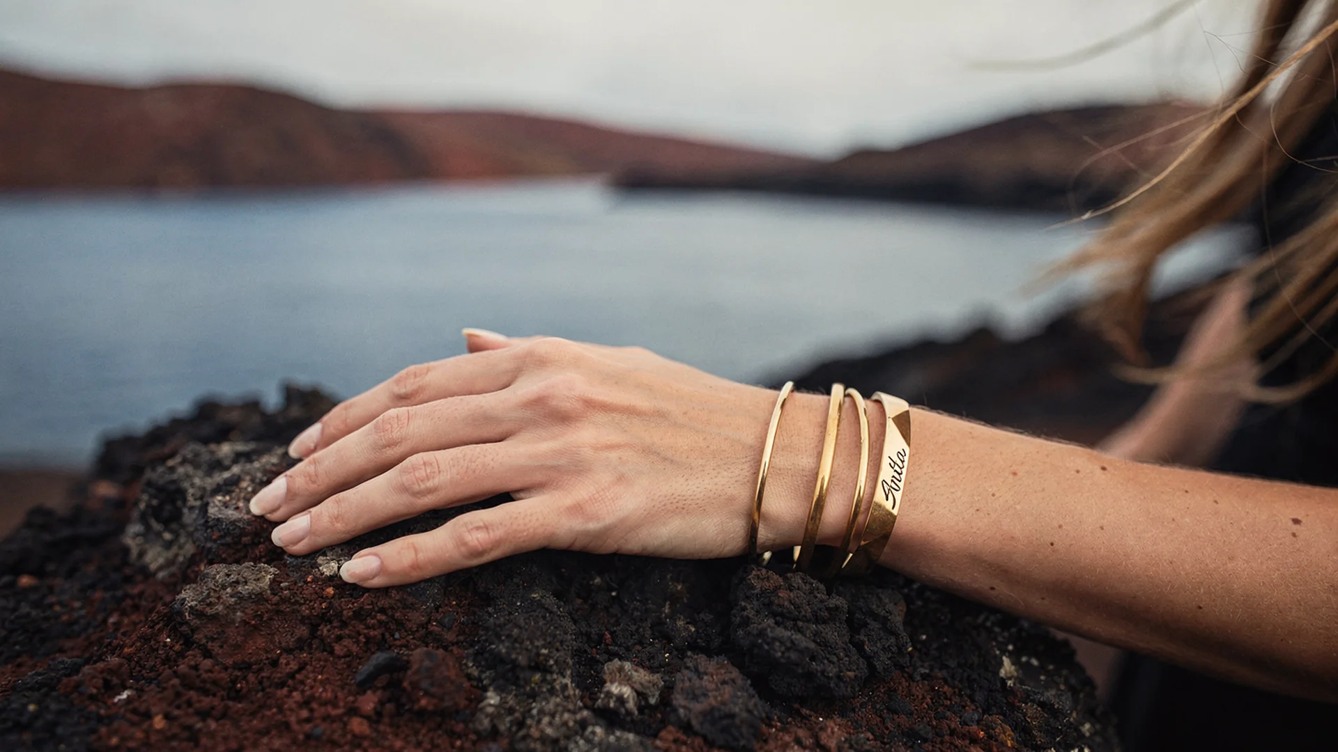 Shopper previewing a gold bangle bracelet on their wrist using virtual try-on on a Shopify jewelry product page