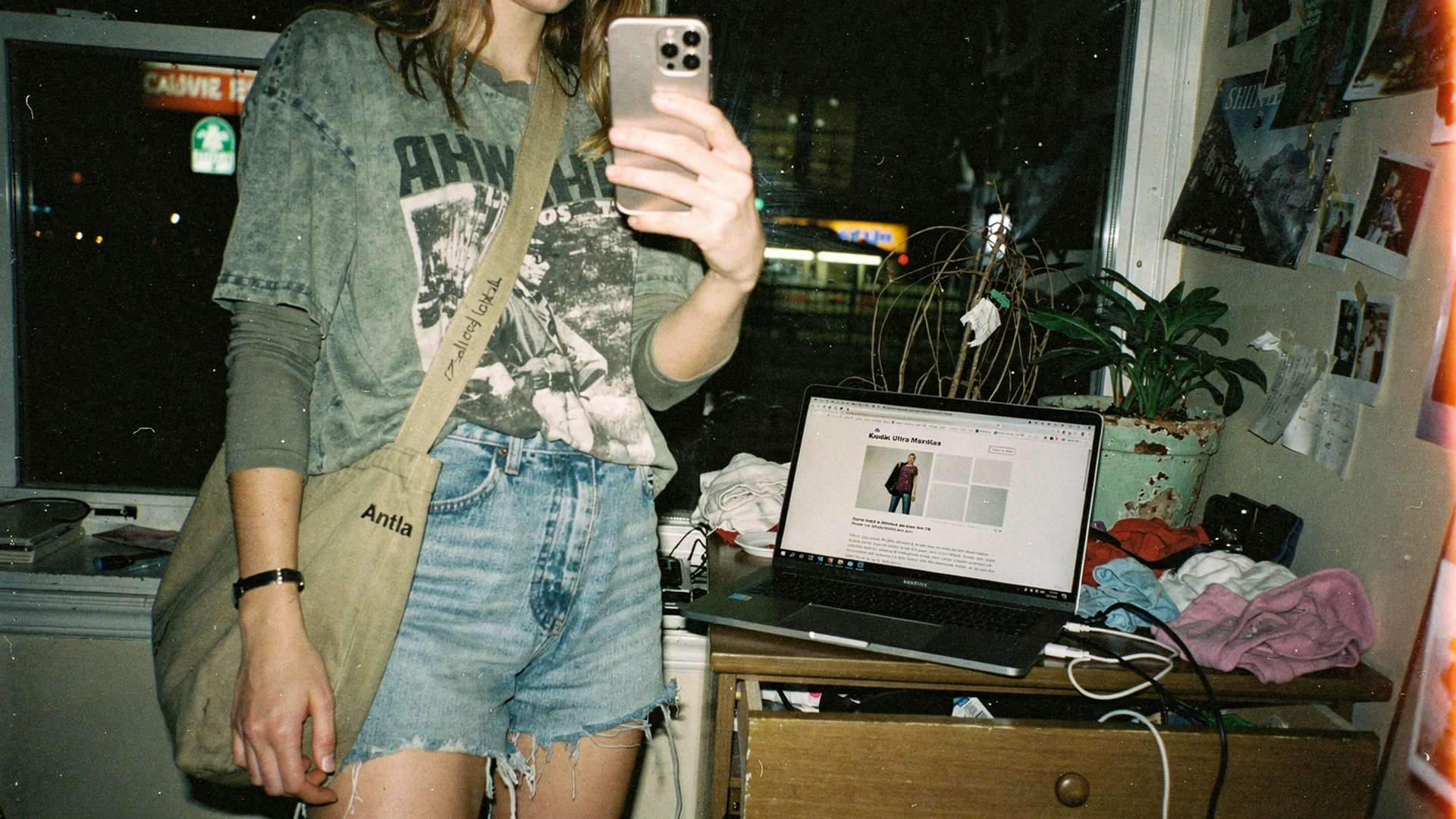 Email designer placing a personalized try-on hero image into a mobile fashion newsletter mockup on a desk