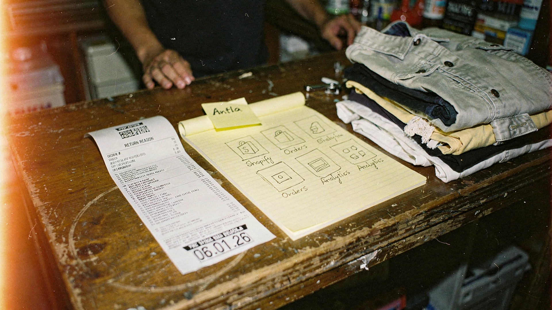 Fashion ecommerce operator comparing Shopify app categories for fit visualization, sizing, reviews, and returns tools on a laptop