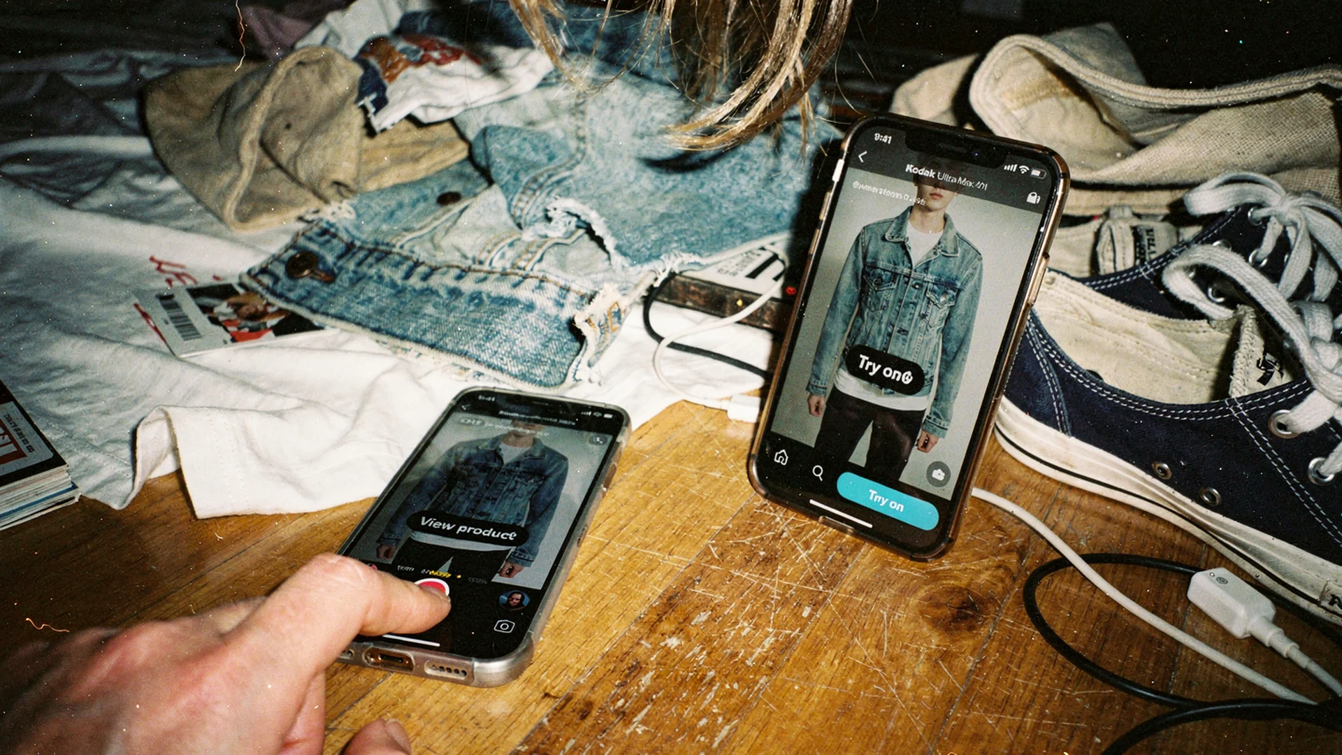 Disposable-camera Antla editorial: fashion brand owner filming an Instagram Story of a jacket beside a phone showing the product page try-on